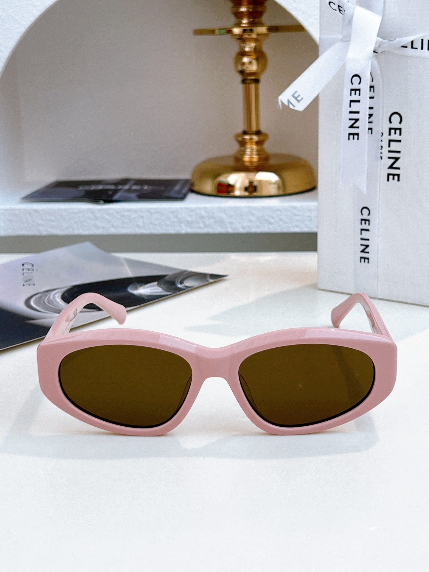 Sunglasses with pink frame and olive-tinted lenses