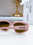 Pink Celine sunglasses with dark lenses and logo detail on the arm
