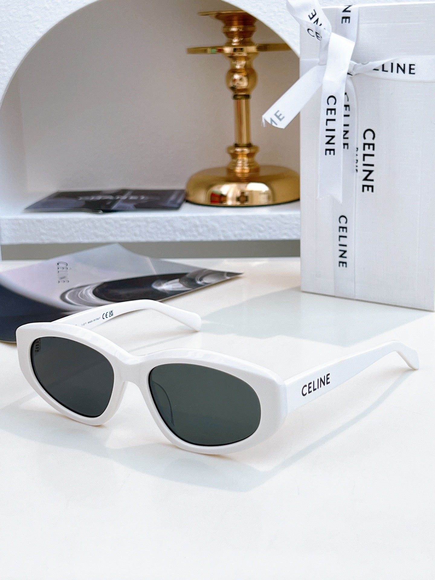 White Celine cat-eye sunglasses with dark green tinted lenses