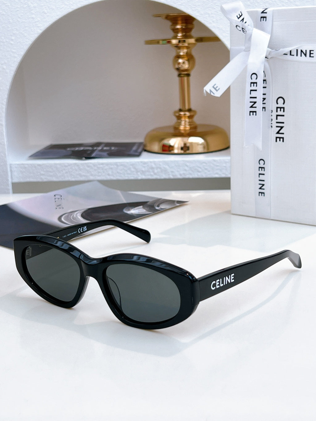 Black Celine cat-eye sunglasses with dark green tinted lenses