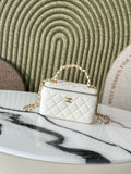 White quilted mini handbag with gold chain strap and top handle, front view.