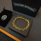 Gold chain bracelet with oval links on a gray jewelry box