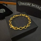Gold oval-link chain bracelet on a dark gray jewelry box