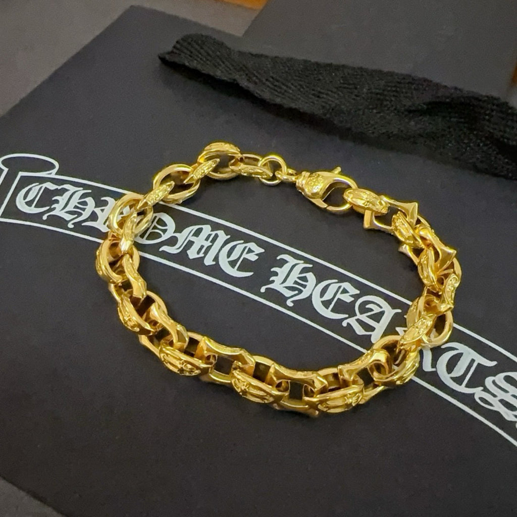 Gold chain bracelet laid on a black gift box