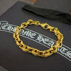 Gold chain bracelet laid on a black gift box