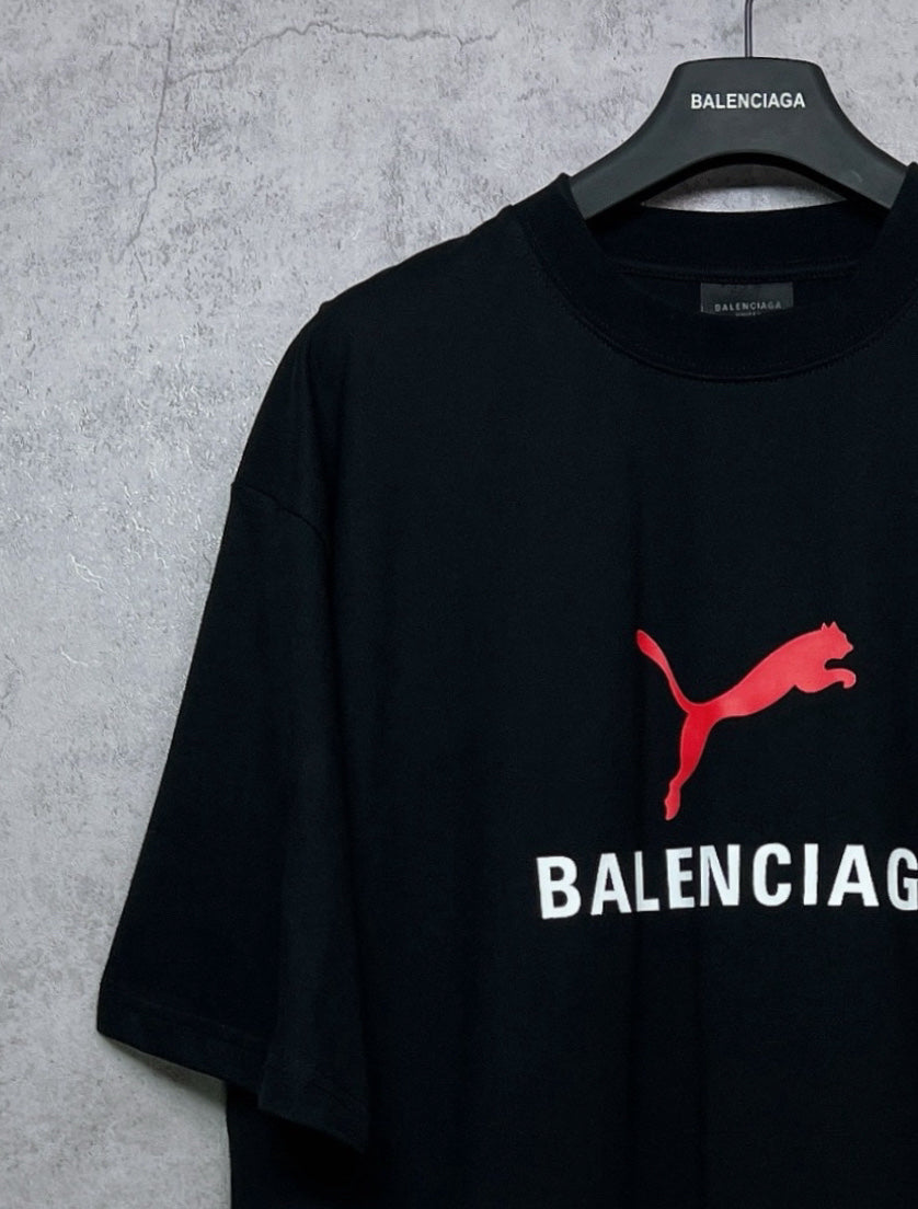Black short-sleeve T-shirt with red puma logo and BALENCIAGA wordmark