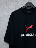 Black short-sleeve T-shirt with red puma logo and BALENCIAGA wordmark