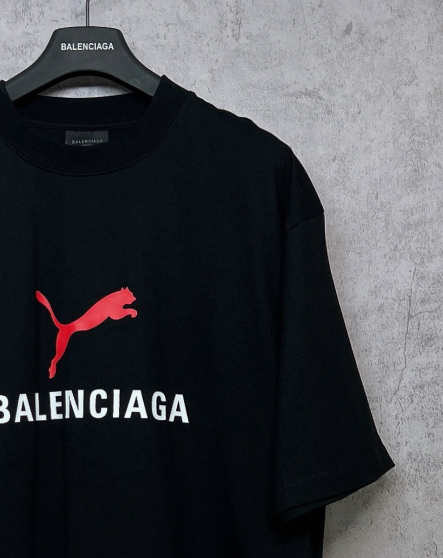 Black short-sleeve T-shirt with red puma logo and partial BALENCIAGA print