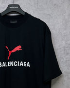 Black short-sleeve T-shirt with red puma logo and partial BALENCIAGA print