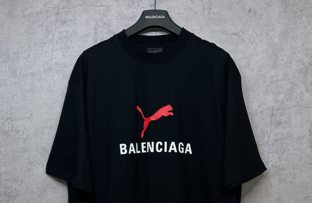 Black short-sleeve T-shirt with red puma logo and BALENCIAGA print on chest