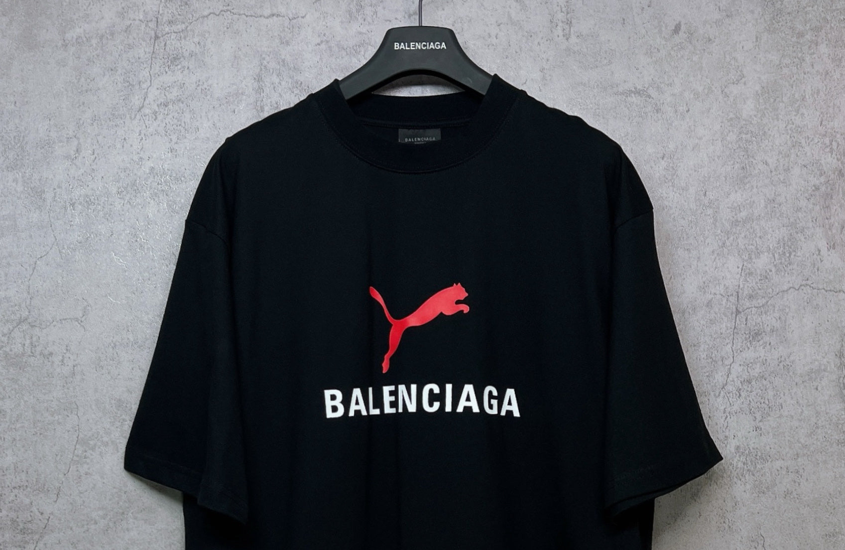 Black short-sleeve T-shirt with red puma logo and BALENCIAGA print on chest