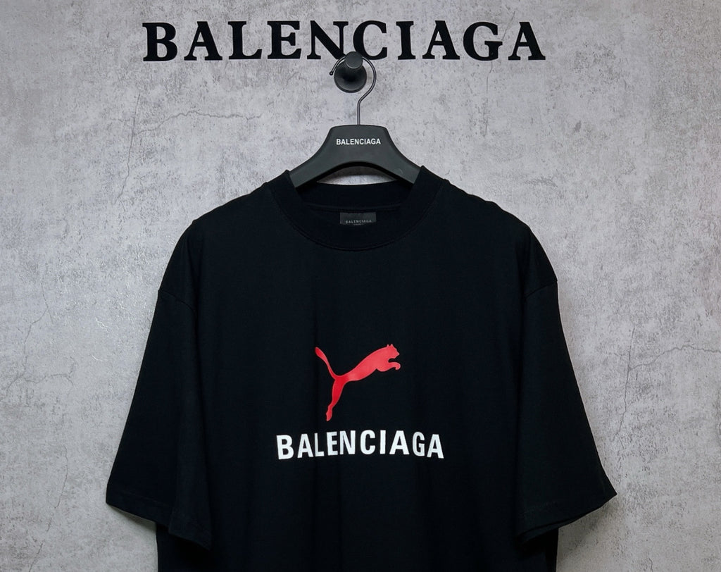 Black short-sleeve T-shirt with red puma logo and BALENCIAGA wordmark