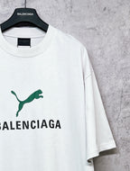 White T-shirt with green emblem and BALENCIAGA print, angled front