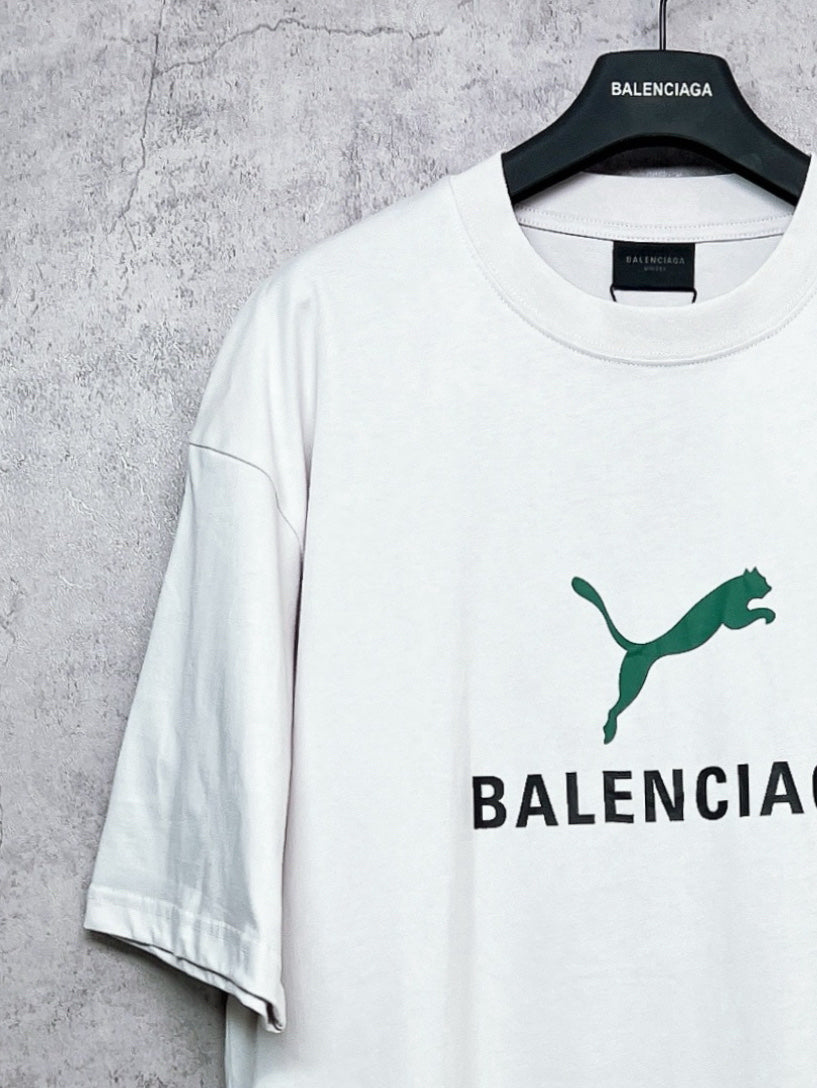 White T-shirt with green emblem and partial BALENCIAGA print