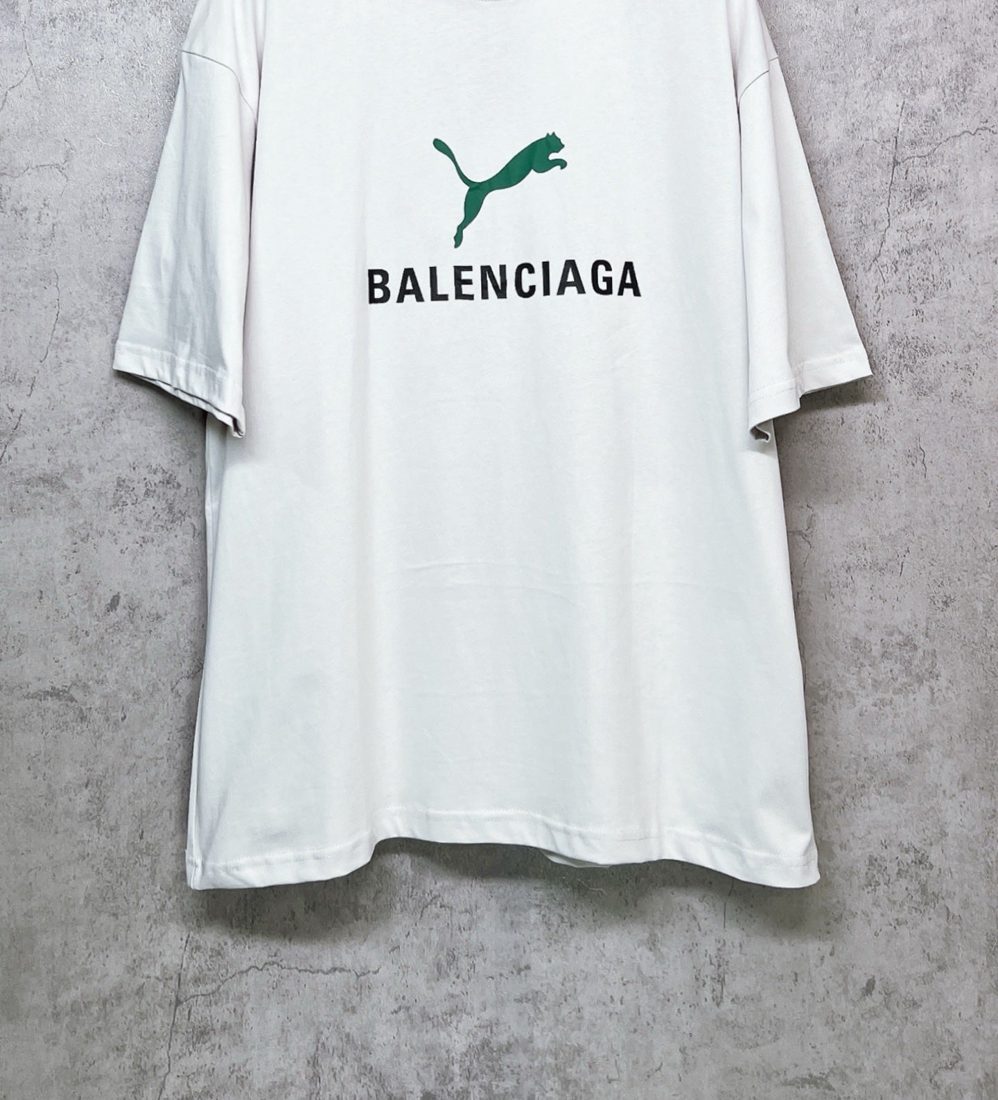 White T-shirt with green emblem and BALENCIAGA lettering on front