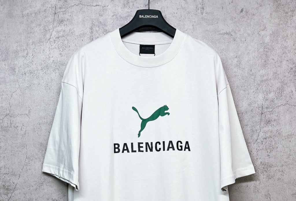White short-sleeve T-shirt with green emblem and BALENCIAGA logo