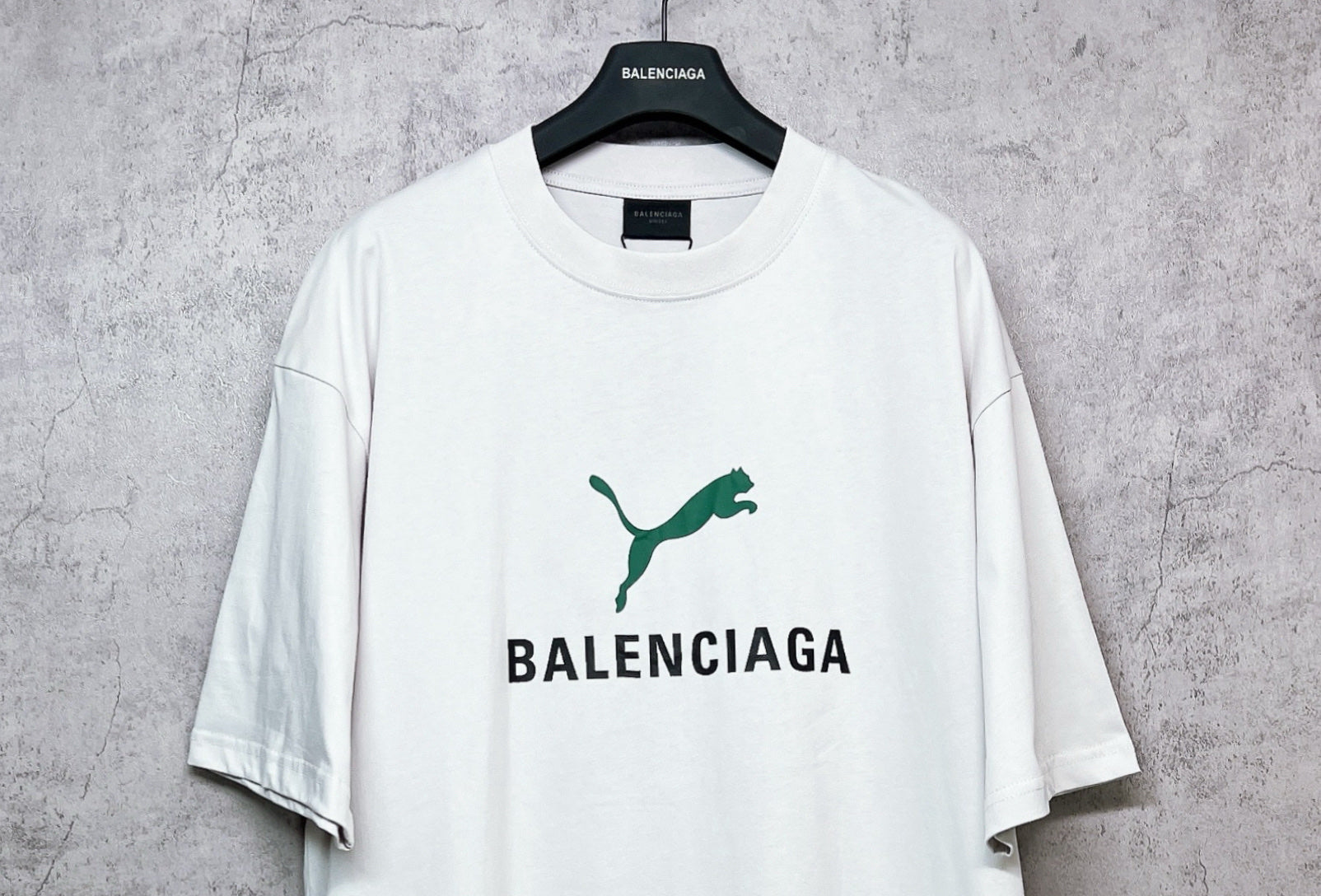 White short-sleeve T-shirt with green emblem and BALENCIAGA logo