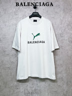 White short-sleeve T-shirt with green emblem and BALENCIAGA front print