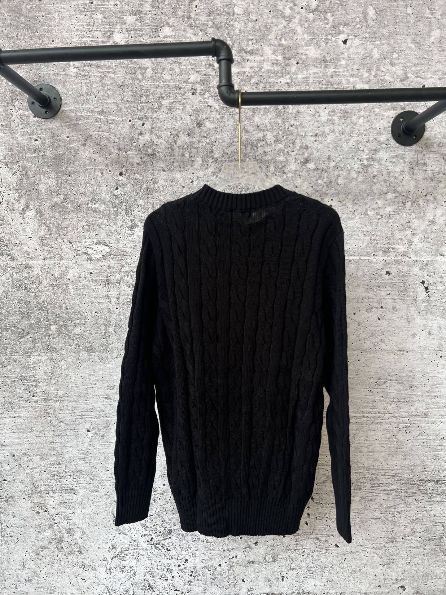 Ralph Lauren cable-knit sweater, long sleeves, crew neck, hanging on rack
