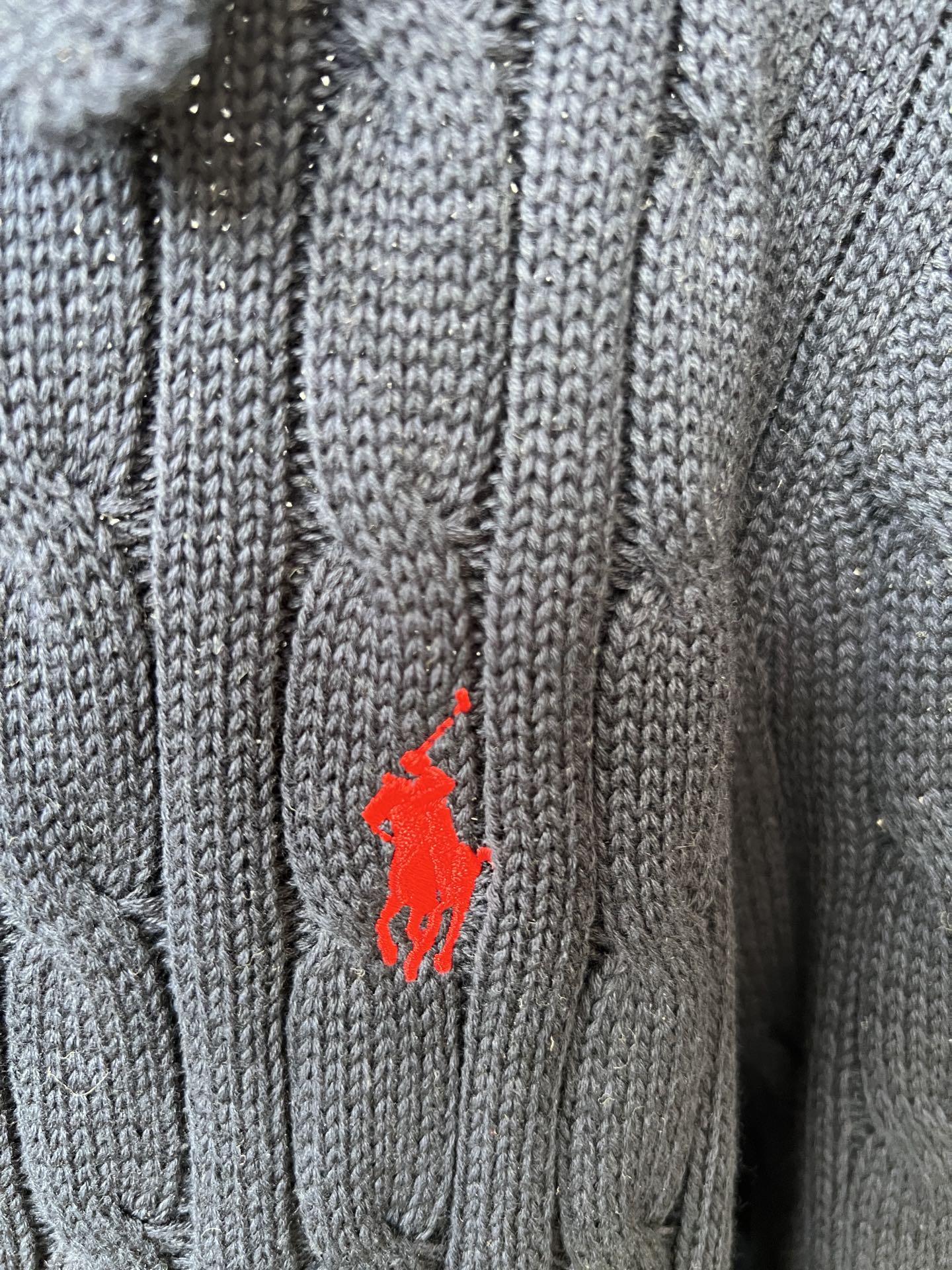 Red Polo pony logo on navy knit polo sweater
