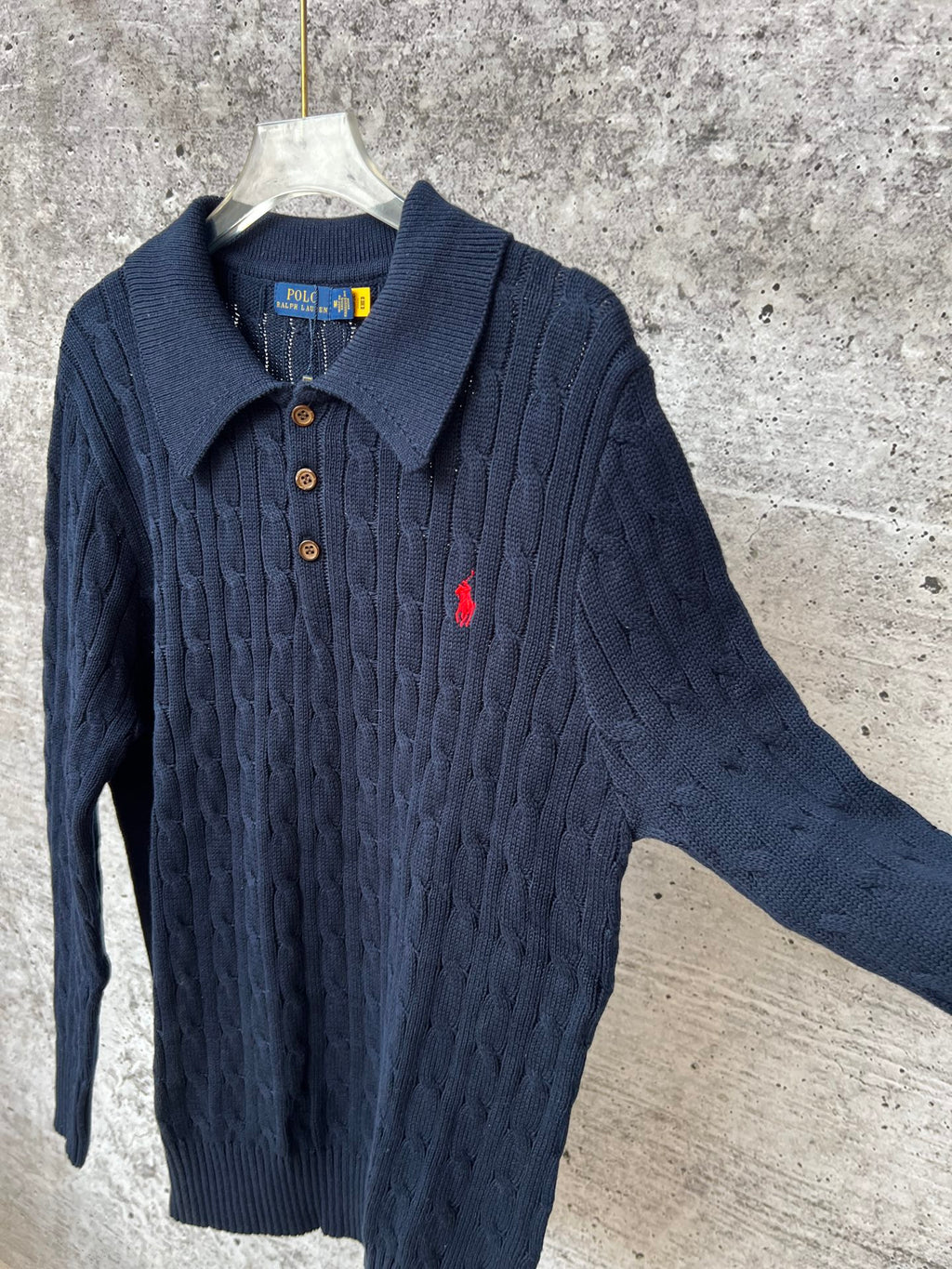 Navy cable-knit long-sleeve polo sweater with collared neck and button placket