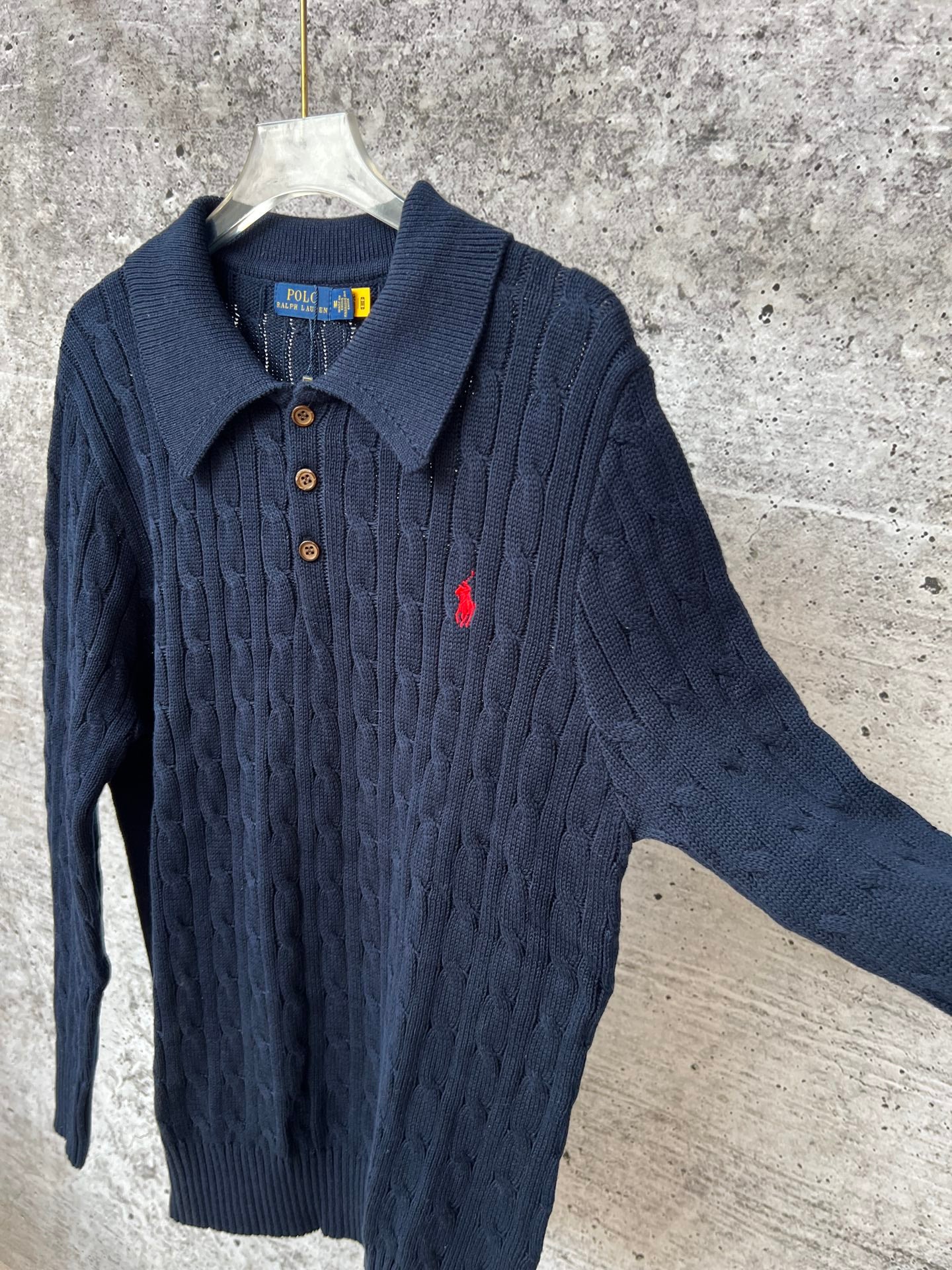 Navy cable-knit long-sleeve polo sweater with collared neck and button placket
