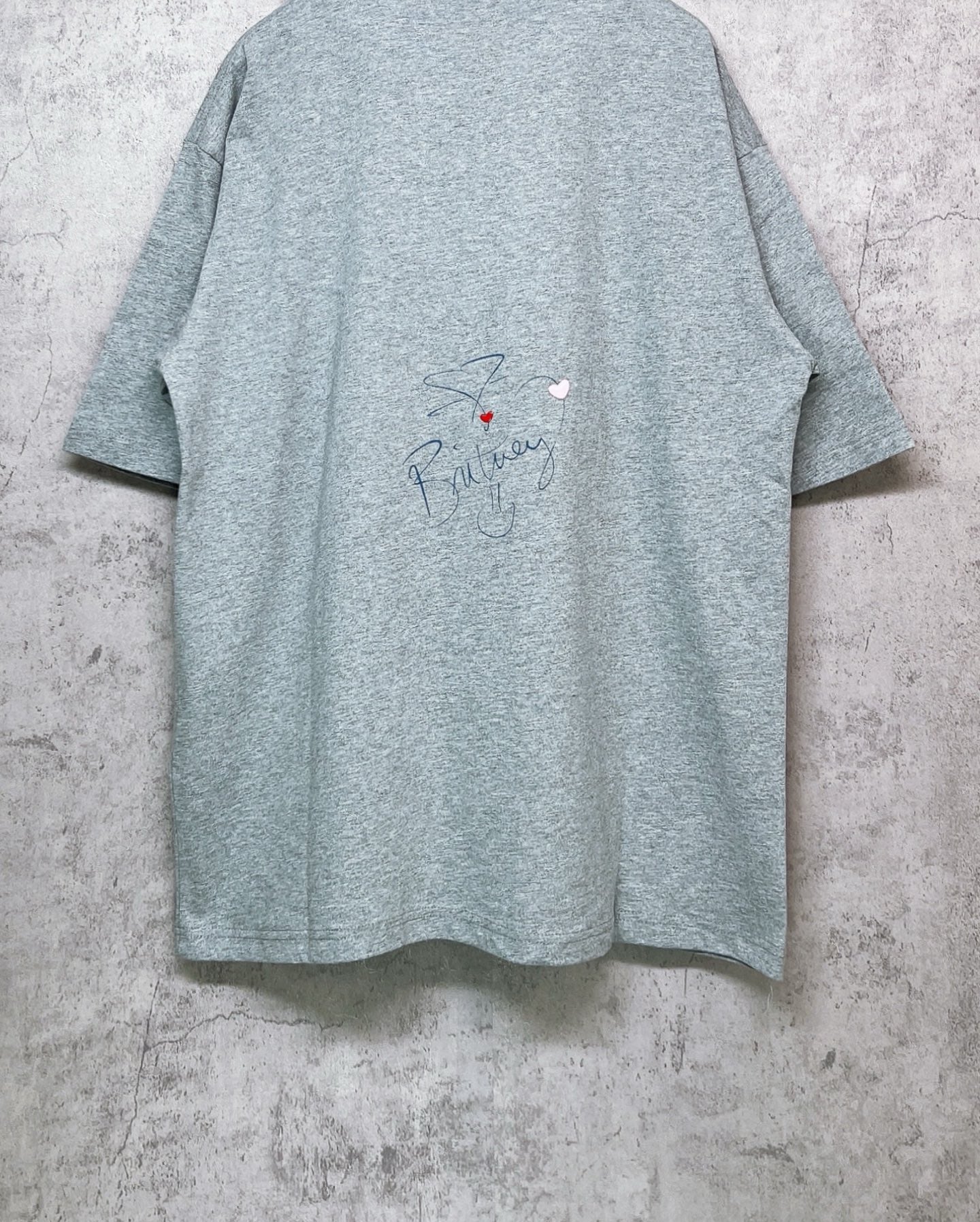Balenciaga heather gray T-shirt back view with cursive signature-style print