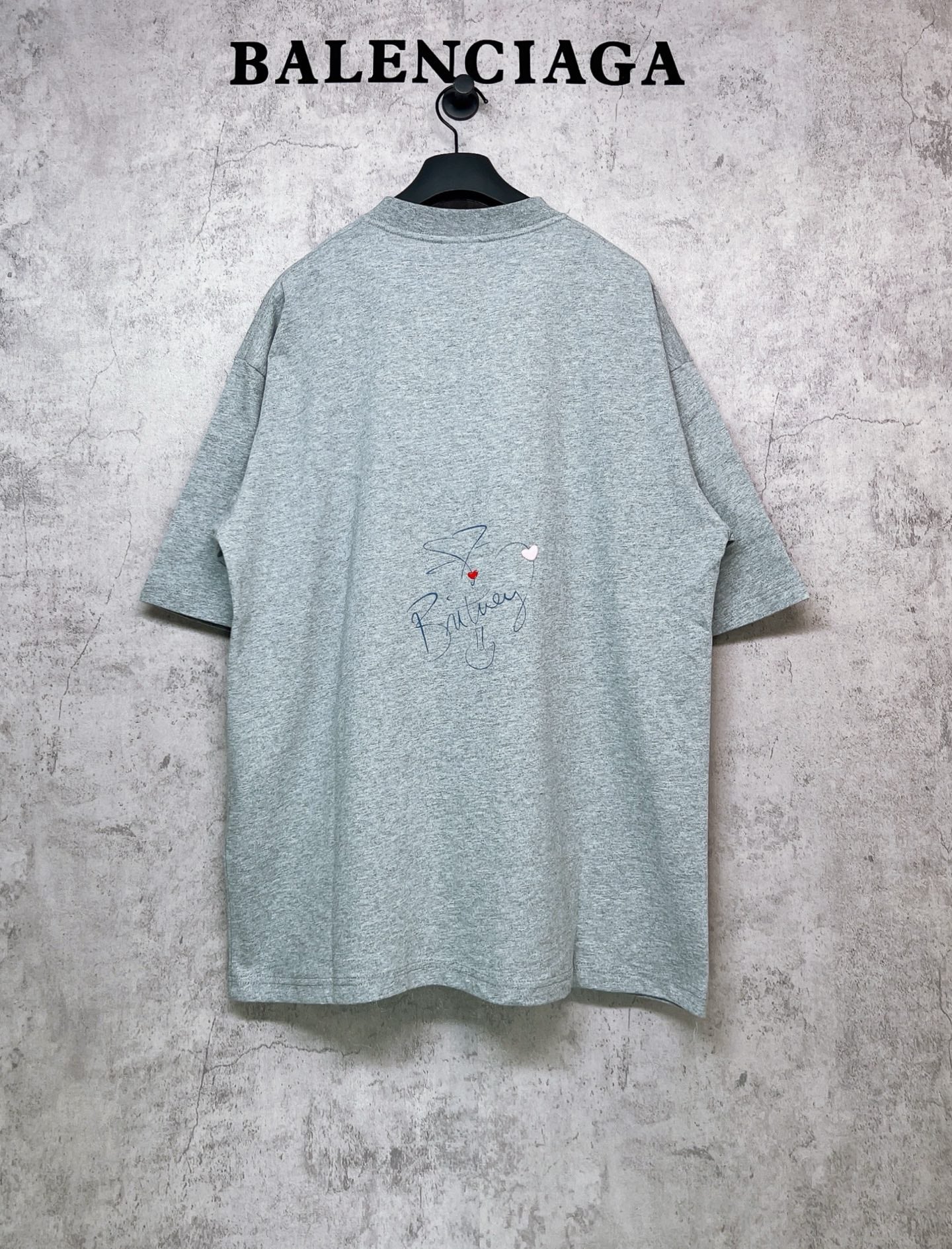 Balenciaga heather gray T-shirt, back view with small signature-style graphic