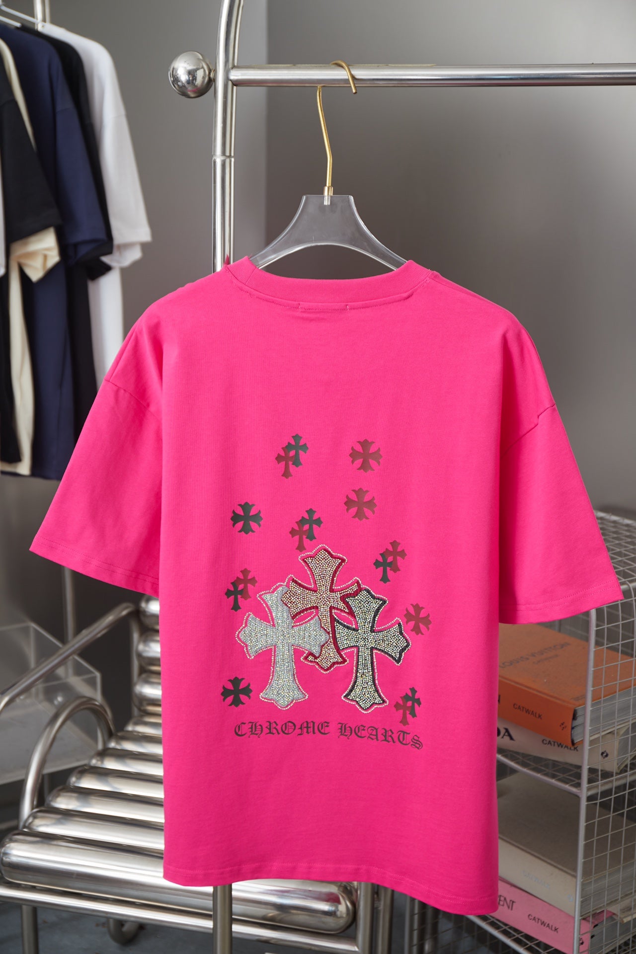 Pink short-sleeve T-shirt with large rhinestone cross print on back