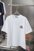 White crewneck short-sleeve T-shirt with small red-and-black cross emblem on chest