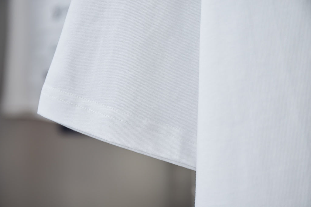 White crewneck short-sleeve T-shirt hem and side seam detail