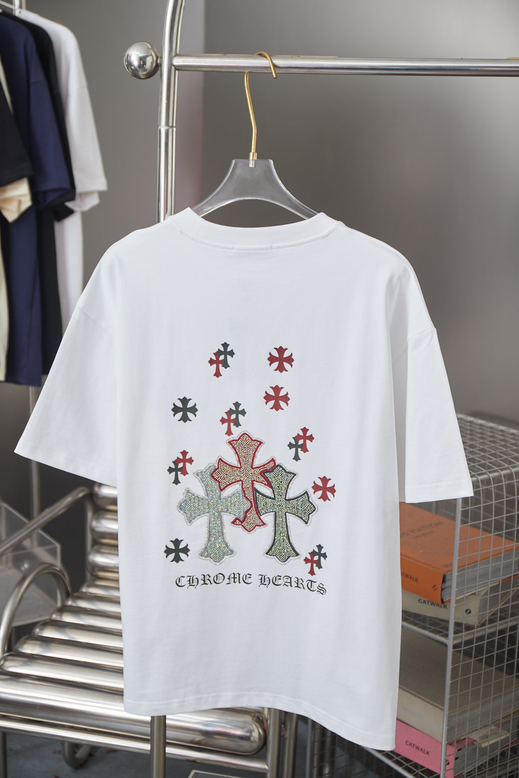 White crewneck short-sleeve T-shirt with cross applique and text on lower back