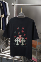 Black short-sleeve T-shirt with large cross and small red emblems on back