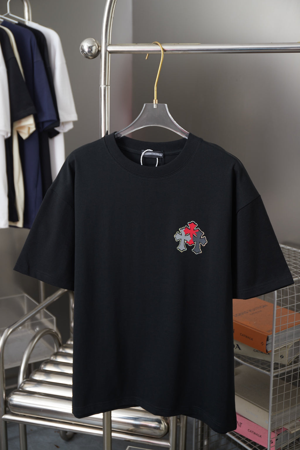 Black short-sleeve T-shirt with red and silver cross graphic on chest