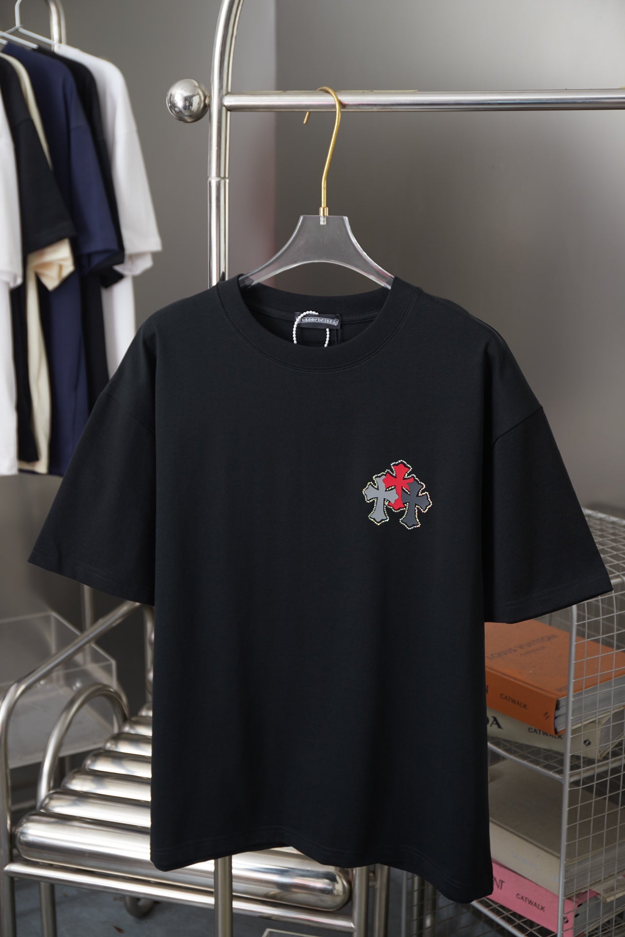 Black short-sleeve T-shirt with red and silver cross graphic on chest