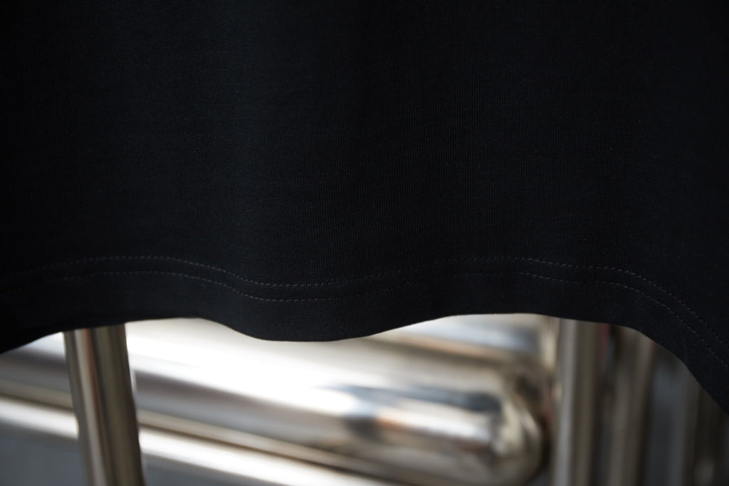 Black T-shirt hem with double-stitched seam