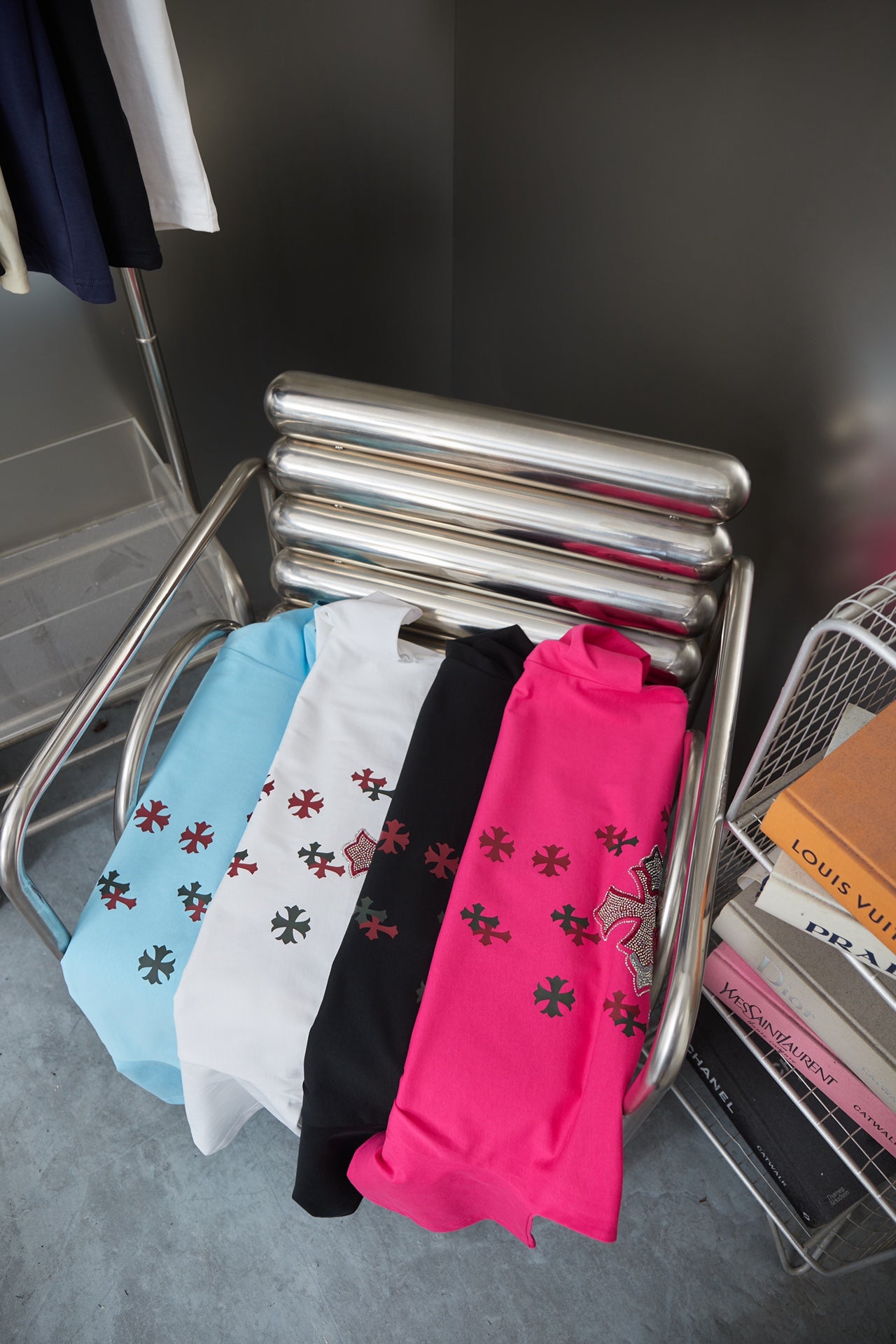 Folded light blue Chrome Hearts short-sleeve T-shirts with cross prints, plus black and pink
