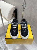 Black Fendi sneakers with white rubber sole, lace-up front, logo patches.