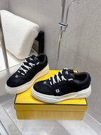 Black Fendi sneakers, white sole and laces, textured side panels and stitching.
