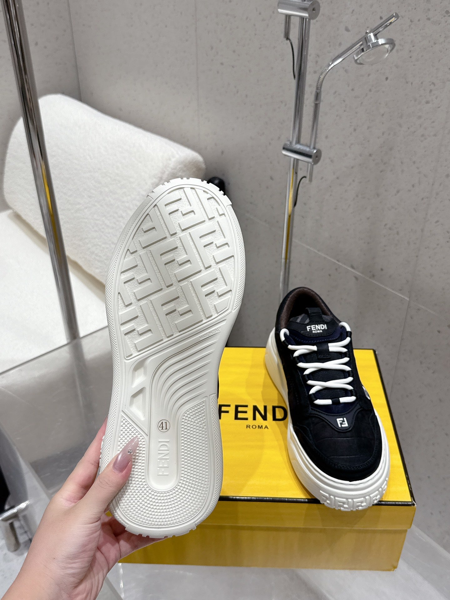 White rubber outsole and black Fendi sneaker, lace-up with F logo tongue.