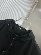 Long jacket close-up: black hood and neckline, front zipper, interior brand label