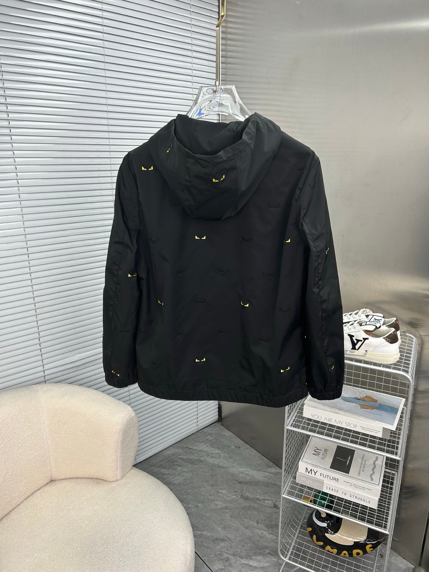 Long hooded jacket in black with yellow mini prints, back view, zipper and pockets