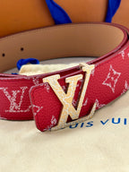 Louis Vuitton belt close-up: red monogram strap with gold LV buckle