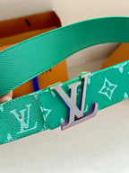 Green Louis Vuitton belt with white monogram print and silver-tone LV buckle close-up