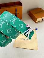 Green Louis Vuitton belt with white monogram and silver-tone LV buckle detail