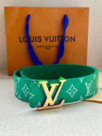 Green Louis Vuitton belt with white monogram pattern and gold-tone LV buckle