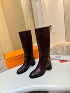 Women's dark brown tall leather boots, angled view with gold-tone side buckle