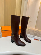 Women's dark brown tall leather boots, front view with gold-tone buckle strap