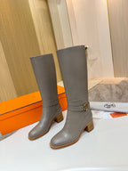 Women’s knee-high gray leather boots with ankle buckle detail and chunky block heel