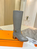 Women’s knee-high heeled boots in gray leather with gold buckle strap at ankle